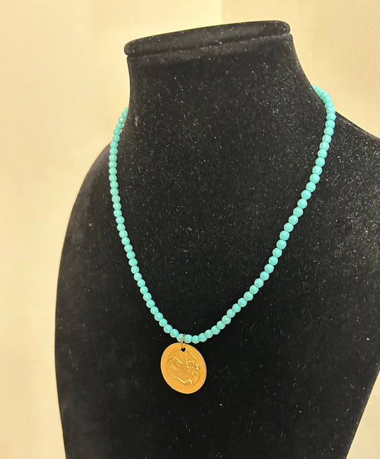 Collana girocollo pietre dure turchesi con ciondolo in ottone